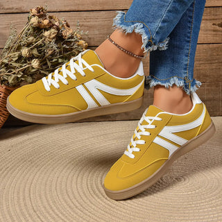Yellow lace-up sneakers with suede finish and rubber outsole designed for comfortable everyday wear.