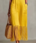 yellow spaghetti strap maxi dress featuring fringe hem detail and pockets